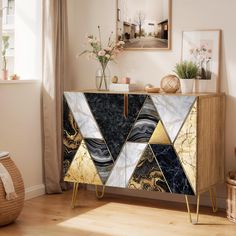 a sideboard with marble and gold accents in a living room