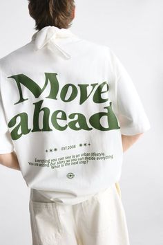 the back of a woman's shirt that says move ahead with green letters on it