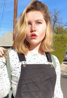 a woman with blonde hair wearing an apron