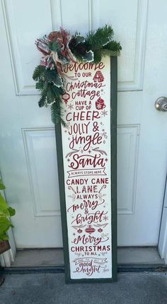 a sign that is on the side of a door saying welcome christmas cheer and joy