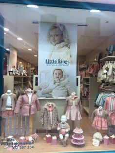 a window display with baby clothes and teddy bears