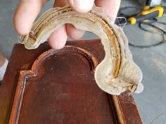 a person holding an old piece of furniture with it's handle extended to the side