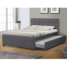 a bed with a trundle that is attached to the headboard and foot board