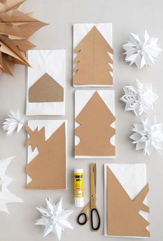 paper snowflakes and other crafting supplies laid out on a white table top