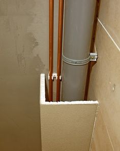 an air conditioner and pipes in a bathroom