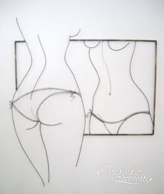 a drawing of two women's butts on a white wall