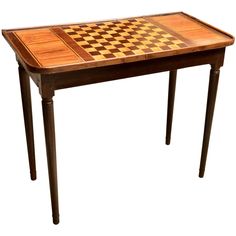 a wooden table with a chess board on it's top and legs in the shape of a checkerboard