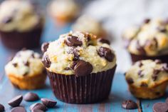 chocolate chip muffins are sitting on a blue surface