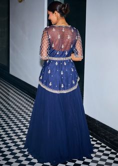 Midnight blue hand embroidered asymmetric peplum. It is embroidered with sequins, stones and beads, features a v neckline and handmade tassels at the sleeves. It is paired with a georgette flowy skirt and a net dupatta. Blue Embellished Sets In Georgette, Blue Bohemian Dupatta With Mirror Work, Festive Peplum Set With Intricate Embroidery, Embellished Blue Evening Dupatta, Blue Embroidered Georgette Fabric With Cutdana, Rahul Khanna, Payal Singhal, Peplum Skirt, Soho Nyc