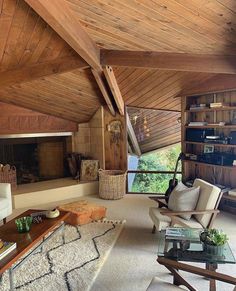 a living room filled with furniture and a fire place in the middle of an open floor plan