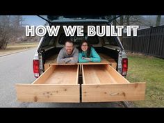 two people sitting in the back of a truck with their arms around each other's waist