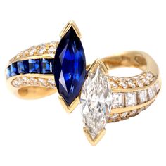 Exquisite "toi et moi" ring showcasing a marquise shape diamond and sapphire, from which a matching line of square diamonds and sapphire goes down on the shank. round brilliant cut diamonds tastefully complement these gemstones. All diamonds are G VS or better and the sapphires have the lovely saturated royal blue colour. The excellent make combined with the high quality of the stones give this timeless design a real "haute joaillerie" feel Diamond marquise: ± 0,85 carat Sapphire marquise: ± 0,9 Luxury Marquise Sapphire Ring In Classic Style, Luxury Multi-stone Sapphire Marquise Ring, Luxury Marquise Sapphire Diamond Ring, Luxury Marquise Sapphire Ring, Luxury Formal Marquise Sapphire Ring, Luxury Marquise Sapphire Ring Fine Jewelry, Luxury Sapphire Marquise Ring With Rose Cut Diamonds, 1920s Engagement Ring Vintage, Royal Blue Colour