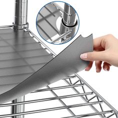 a hand is holding the handle on a metal structure that has been constructed into a triangular shape