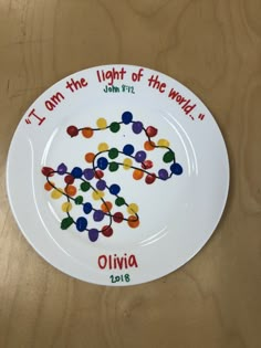 a white plate with the words i am the light of the world written on it