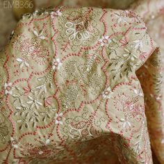 closeup of the back of a chair covered in pink and gold brocades