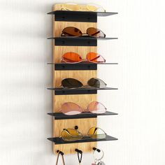 a wall mounted shelf with sunglasses on it