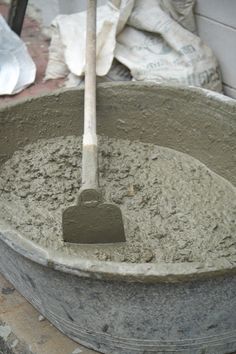 there is a shovel in the cement bucket