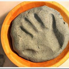 a wooden bowl filled with cement on top of a table