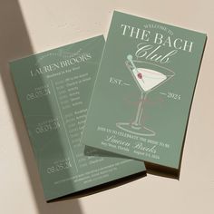 two green and white cocktail menus sitting on top of each other