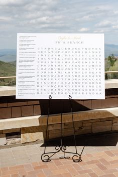 a sign that is sitting on top of a stone bench in front of a building