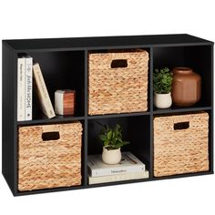 an open shelf with four baskets and books