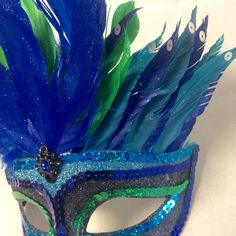 Peacock mask, peacock masquerade mask, mardi gras mask, half mask, peacock costume, gatsby party mask, masquerade party mask, feather mask Gorgeous glitter peacock mask adorned with blue and green feathers. Has an elastic band. Feathered Masquerade Mask For Mardi Gras, Feathered Eye Mask For Carnival, Feathered Masks For Mardi Gras Carnival, Peacock Masquerade, Masquerade Party Mask, Peacock Mask, Peacock Costume, Green Feathers, Feather Mask