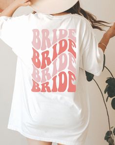 a woman wearing a white t - shirt with the word bride on it