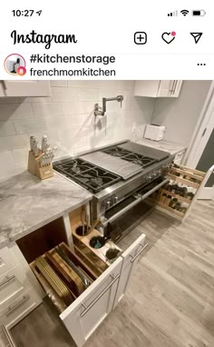 an open drawer in the middle of a kitchen