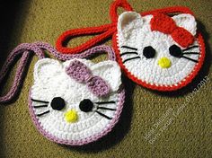 two crocheted hello kitty purses sitting on top of a carpeted floor