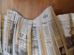 several newspapers spread out on a wooden table