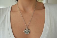 It's an amazing short antique silver coin necklace with an engraved Evil Eye protection pendant. If you're looking for a delicate feminine necklace - yet supernatural, easy to wear that's the perfect jewelry for you. The Evil Eye is a popular symbol, found in many cultures and it is extremely prominent in Greece and many more Eastern countries. The Evil Eye is a curse cast by a malevolent stare. In Greek culture though the evil eye can be cast from the stares of admiration too. The victims suffe Bohemian Evil Eye Metal Jewelry, Bohemian Stainless Steel Nickel Free Necklaces, Silver Delicate Chain Bohemian Jewelry, Bohemian Silver Jewelry With Delicate Chain, Silver Bohemian Jewelry With Delicate Chain, Bohemian Sterling Silver Coin Necklace As Gift, Bohemian Sterling Silver Coin Necklace For Gift, Vintage Silver Charm Necklace With Delicate Chain, Bohemian Sterling Silver Evil Eye Jewelry