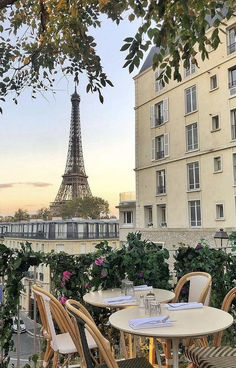 tables and chairs with the eiffel tower in the background