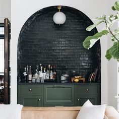 a living room filled with furniture and lots of bottles