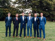 a group of men in suits standing next to each other