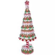 a christmas tree made out of candy canes and gingerbreads is shown on a white background