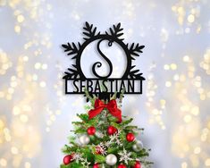 there is a christmas tree with ornaments on it and the name sebastann