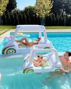 two people are in the pool with an inflatable float and one person is sitting