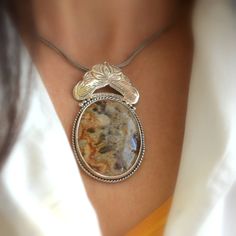 "Crazy lace agate necklace sterling silver large oval lace agate pendant orange brown beige antique bohemian style, artisan boho jewelry A beautiful large oval crazy lace agate stone with hues of brown, beige and orange in sterling silver statement pendant. Lovely autumn colors and winter colors too. The stone is set inside a bezel and framed with braided wire . On top of it there is an engraved antique floral pattern. I have oxidized it to bring out the details and achieved this bohemian look T Bohemian Jewelry With Oval Pendant Natural Stones, Handmade Bohemian Oval Jewelry, Handmade Oval Bohemian Jewelry, Bohemian Pendant Jewelry With Large Stone, Bohemian Sterling Silver Necklace With Large Stone, Bohemian Brown Necklace With Large Stone, Bohemian Silver Necklace With Large Stone, Bohemian Medallion Jewelry With Natural Stones, Bohemian Agate Round Pendant Jewelry