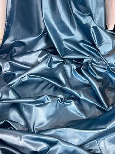 the fabric is shiny blue and it looks like silk or polyestere satin material