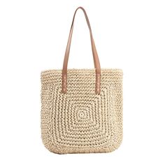 a straw tote bag with leather handles on the front and side, in natural colors