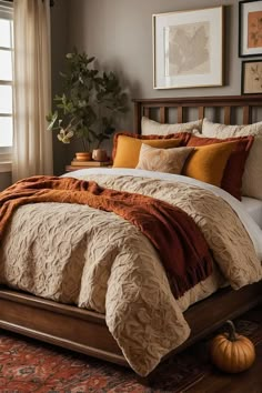 a bed with orange and brown comforters in a bedroom