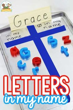 a metal tray with letters and numbers on it that are in front of a blue cross