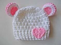 Welcome to our adorable collection of handmade baby accessories! Our crochet baby bear hat in pure white, adorned with a sweet pink heart accent, is designed to keep your little one both cozy and charming.     Exceptional Softness: Crafted from the finest yarn, this hat ensures your baby's comfort with its soft and gentle touch.   The hand-crocheted pink heart adds a touch of love and cuteness to this classic white hat.     Perfect Fit: Available in various sizes, this hat guarantees a snug and White Adjustable Beanie For Babies, Whimsical White Mini Cap Hat, Cute White Crochet Hat For Gift, Cute White Crochet Hat For Gifts, Cute White Crochet Hat As Gift, Cute Cream Hat For Gift, Cute White Hat For Birthday, Cute Pink Crochet Hat, Whimsical White Mini Hat For Gifts