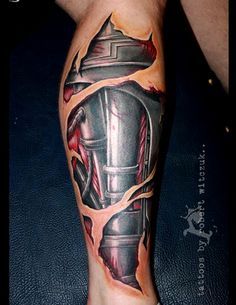 a man's leg with a tattoo on it that has an image of a helmet