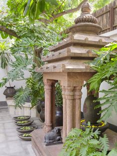 an outdoor area with potted plants and statues