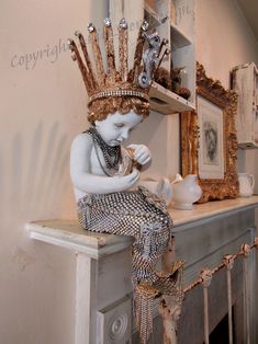 a white statue sitting on top of a mantle