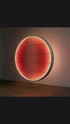 an illuminated circular object in the middle of a room with a light shining on it