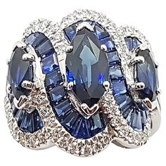 Blue Sapphire 1.93 carats (Center Marquise) with Blue Sapphire 1.55 cts (Total Side Marquises) with Sapphire 7.92 carats (Total Baguette) and Diamond 0.57 carat Ring set in 18 Karat White Gold Settings Width: 2.0 cm Length: 2.0 cm Ring Size: 52 Total Weight: 11.33 grams "We first opened doors in 1980 when it was then situated in the vicinity of the Victory Monument; a small and modest storefront with a couple of counters. From its humble beginnings to where it stands today, our company has prove Luxury Blue Marquise Cut Jewelry, Blue Sapphire Ring With Multi-stone Baguette Cut, Blue Sapphire Multi-stone Baguette Ring, Blue Multi-stone Baguette Cut Sapphire Ring, Luxury Blue Marquise Cut Ring, Luxury Blue Marquise Rings, Dazzling Blue Diamond Gemstones, Luxury Blue Marquise Jewelry, Luxury Blue Multi-stone Diamond Ring