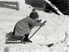 an old black and white photo of a person on skis in the snow