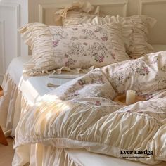 an unmade bed with ruffled sheets and pillows